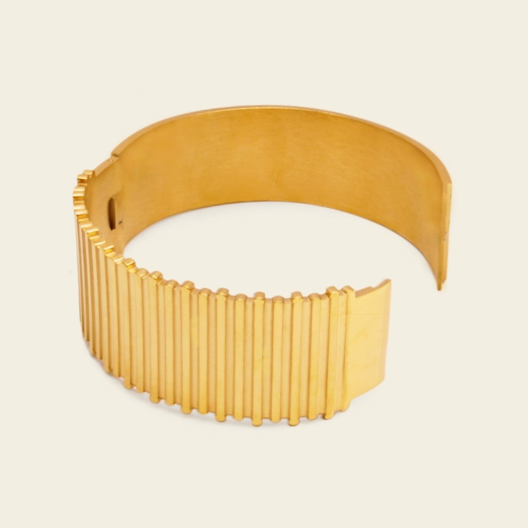 Fluted Ridge Bangle with a broad vertically ridged band in gold finish