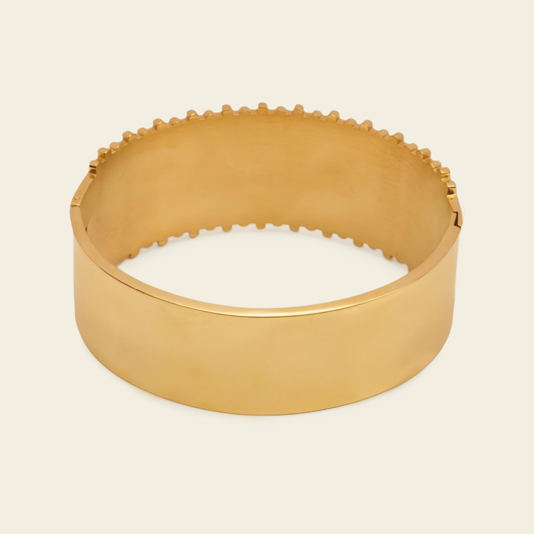 Fluted Ridge Bangle with a broad vertically ridged band in gold finish