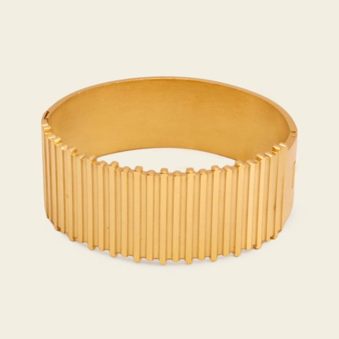 Fluted Ridge Bangle with a broad vertically ridged band in gold finish