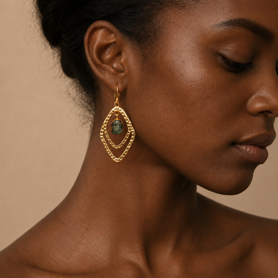 Forest Halo Earrings worn on the ear, with layered leaf-shaped frames and dark green stone centres