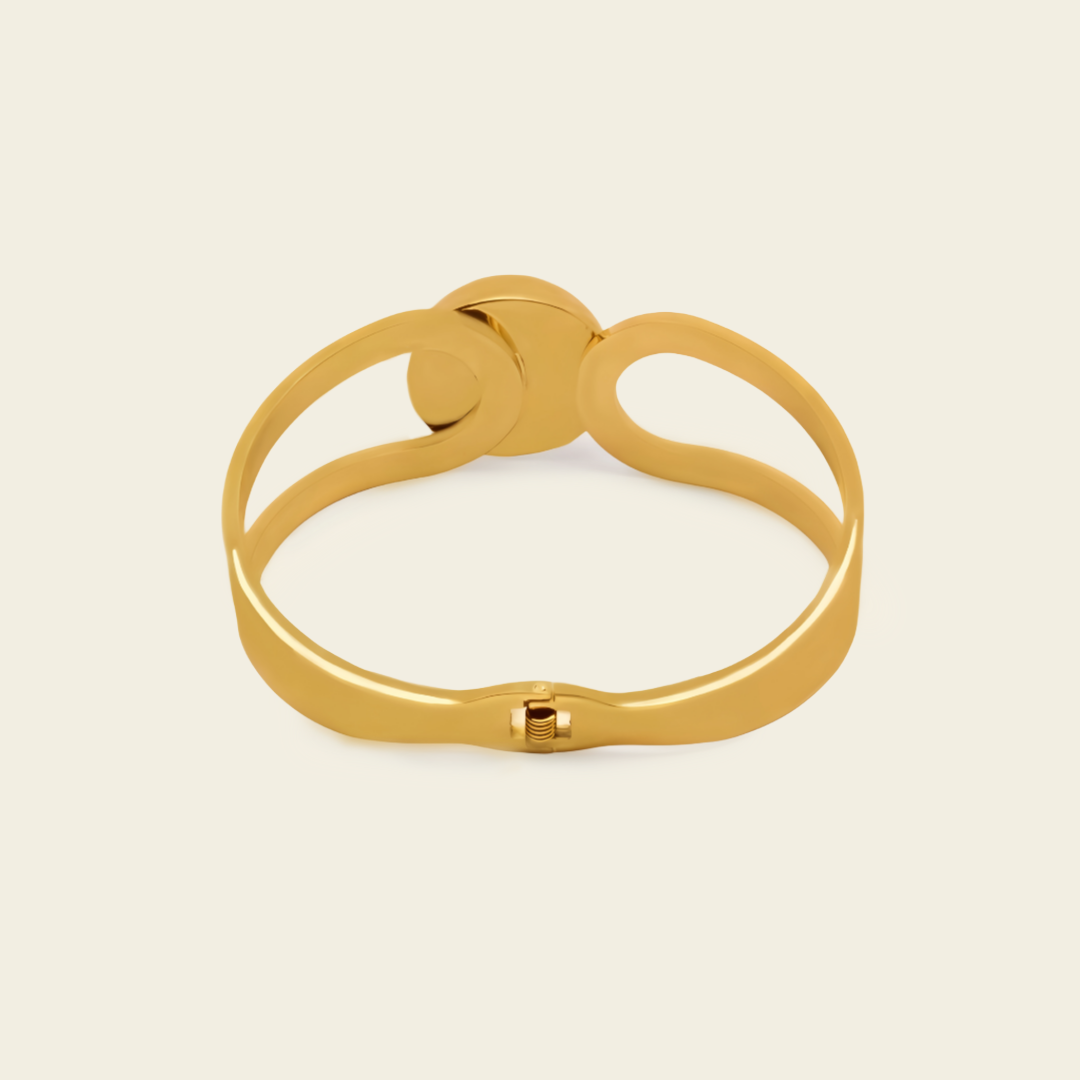 Framed Orb Bangle with an open frame and polished spherical centre in gold finish