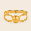 Framed Orb Bangle with an open frame and polished spherical centre in gold finish