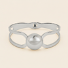 Framed Orb Bangle with an open frame and polished spherical centre in silver finish