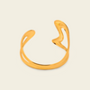 Freeform Loop Cuff with a sculptural open band with flowing looped ends in gold finish