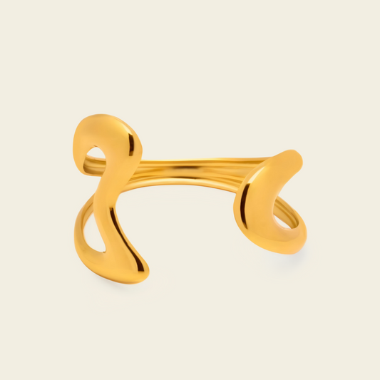 Freeform Loop Cuff with a sculptural open band with flowing looped ends in gold finish
