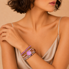 Gentle Mark Bracelet worn on the wrist, with layered pale pink and purple beads