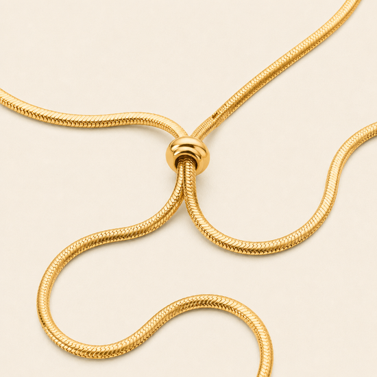 Glide Drop Necklace with a smooth collar with a flowing lariat drop in gold finish