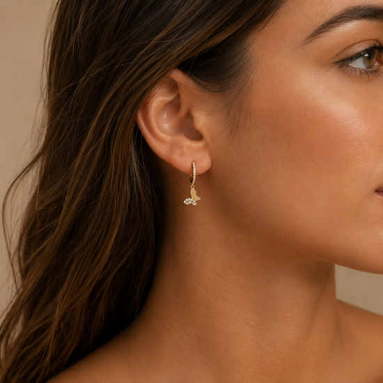 Grace Wing Earrings worn on the ear in gold finish