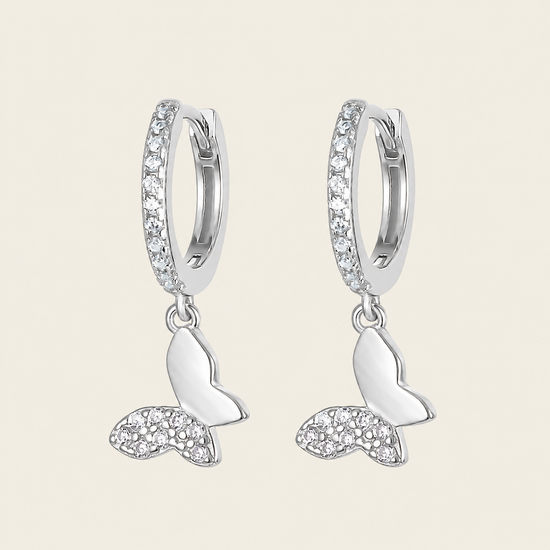 Grace Wing Earrings with butterfly charms suspended from small hoops in silver finish