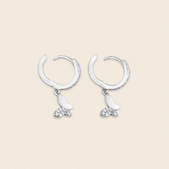 Grace Wing Earrings with butterfly charms suspended from small hoops in silver finish