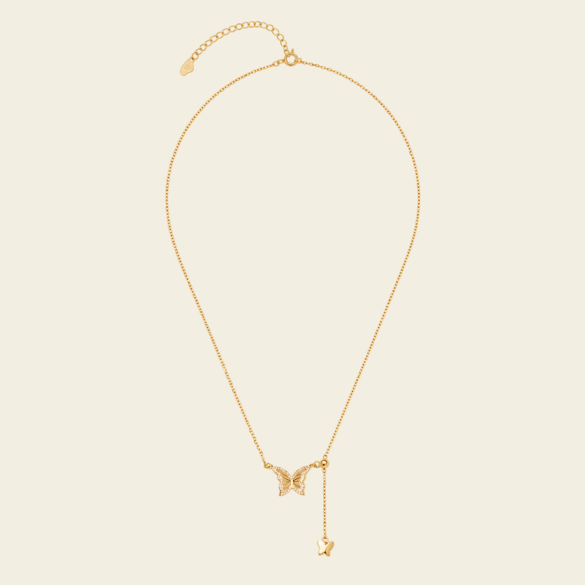 Grace Wing Necklace with a butterfly motif and a hanging clear stone in gold finish