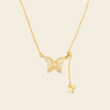 Grace Wing Necklace with a butterfly motif and a hanging clear stone in gold finish