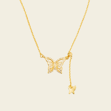 Grace Wing Necklace with a butterfly motif and a hanging clear stone in gold finish