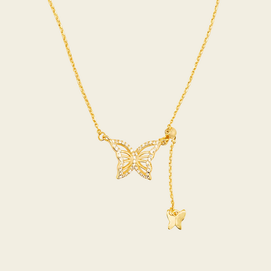 Grace Wing Necklace with a butterfly motif and a hanging clear stone in gold finish