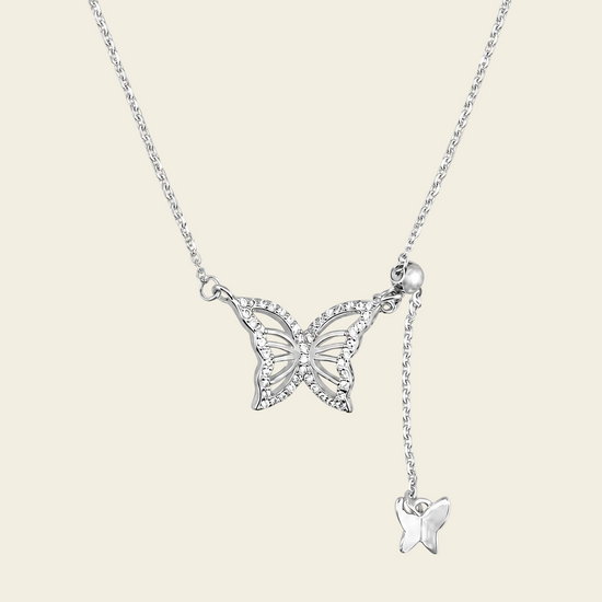 Grace Wing Necklace with a butterfly motif and a hanging clear stone in silver finish