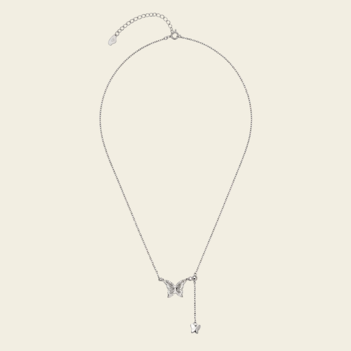 Grace Wing Necklace with a butterfly motif and a hanging clear stone in silver finish
