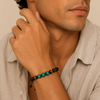 Green Axis Bracelet with green and dark round beads with an adjustable cord