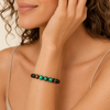 Green Axis Bracelet worn on the wrist, with green and dark round beads with an adjustable cord