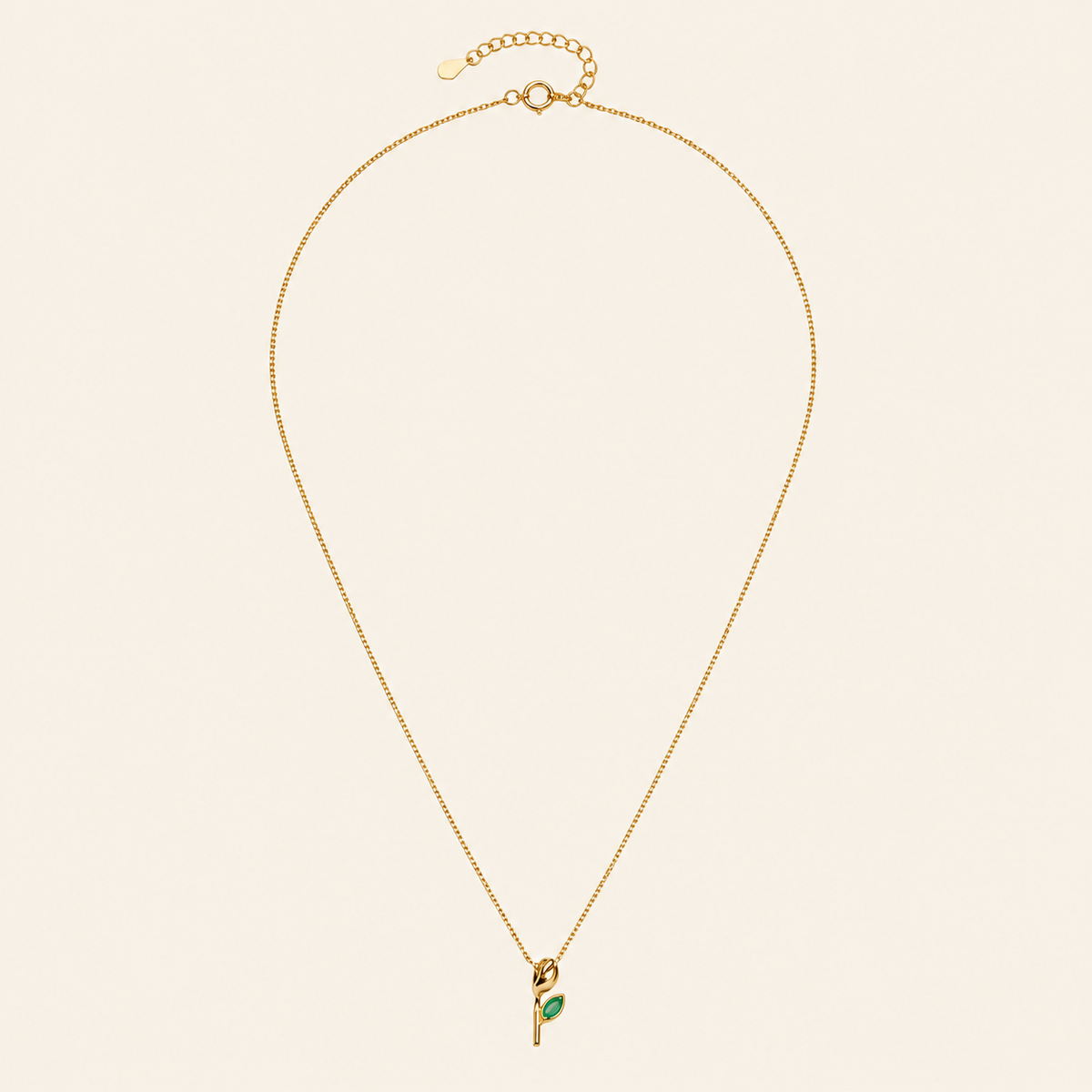 Green Bloom Necklace with a slender stem pendant and green leaf-shaped stone in gold finish