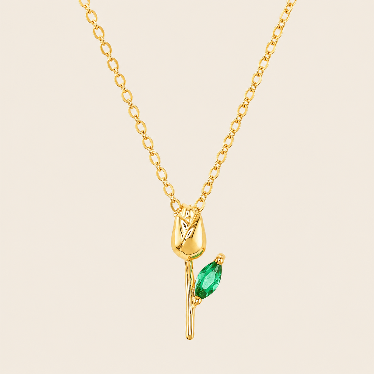 Green Bloom Necklace with a slender stem pendant and green leaf-shaped stone in gold finish