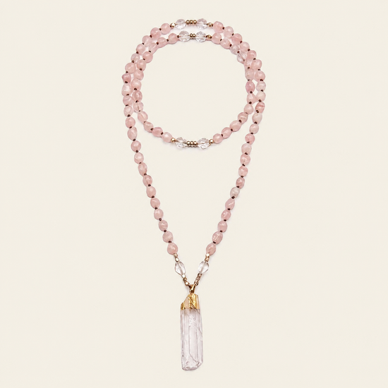 Hushed Point Necklace with pale pink beads and a translucent pointed pendant