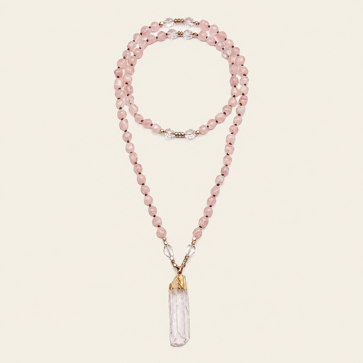 Hushed Point Necklace with pale pink beads and a translucent pointed pendant