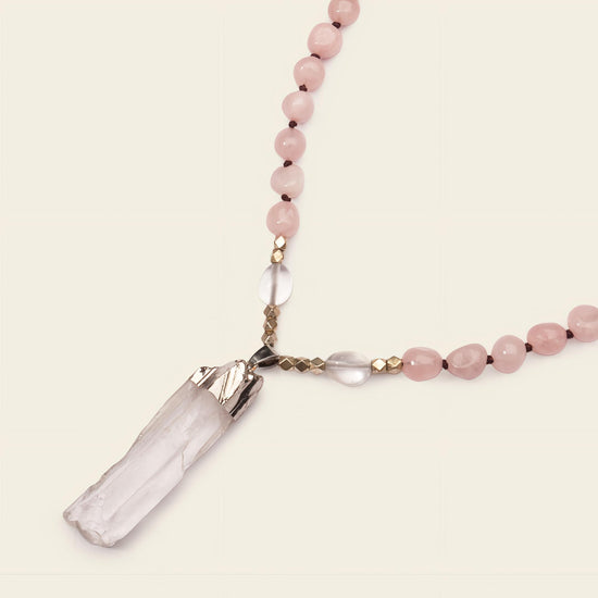 Hushed Point Necklace with pale pink beads and a translucent pointed pendant