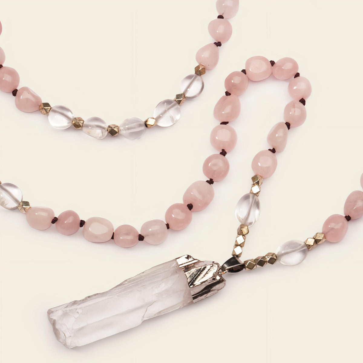 Hushed Point Necklace with pale pink beads and a translucent pointed pendant