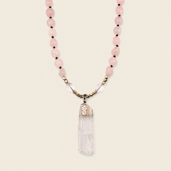 Hushed Point Necklace with pale pink beads and a translucent pointed pendant