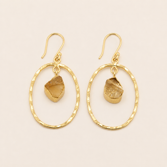 Inner Halo Earrings with open circular frames and small warm-toned stone drops