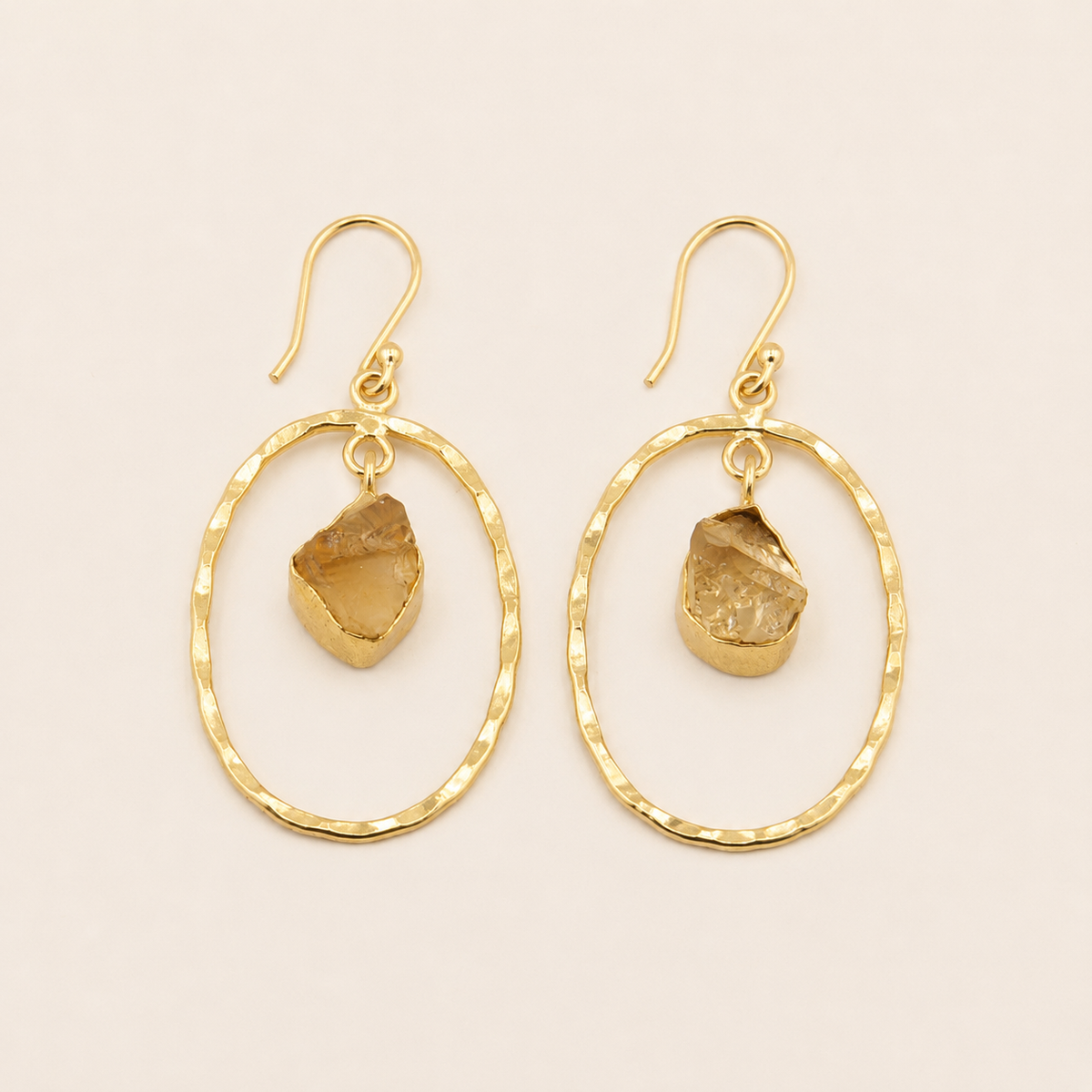 Inner Halo Earrings with open circular frames and small warm-toned stone drops