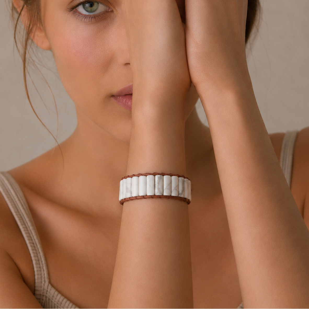 Ivory Tile Bracelet worn on the wrist, with white veined stone tiles on brown cord