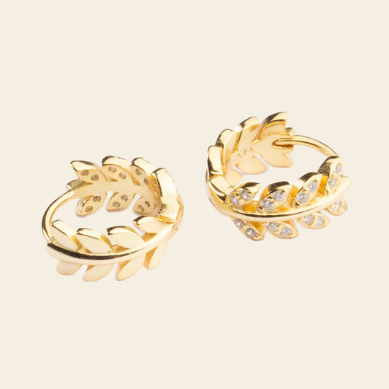 Laurel Arc Earrings with small hoops with leaf-shaped details in gold finish