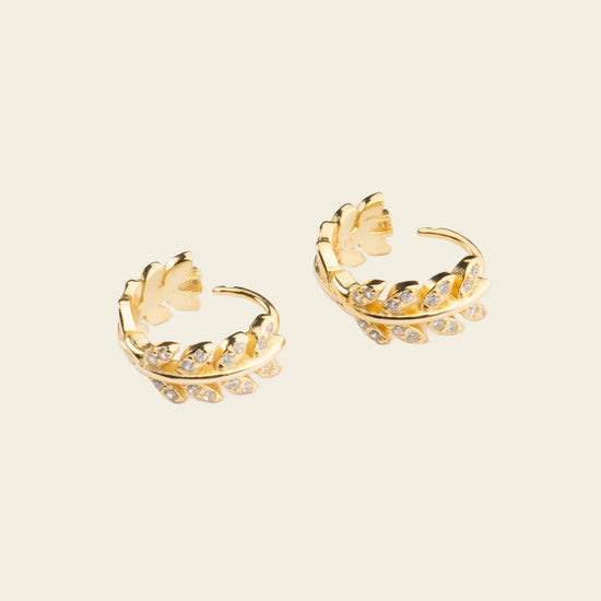 Laurel Arc Earrings with small hoops with leaf-shaped details in gold finish