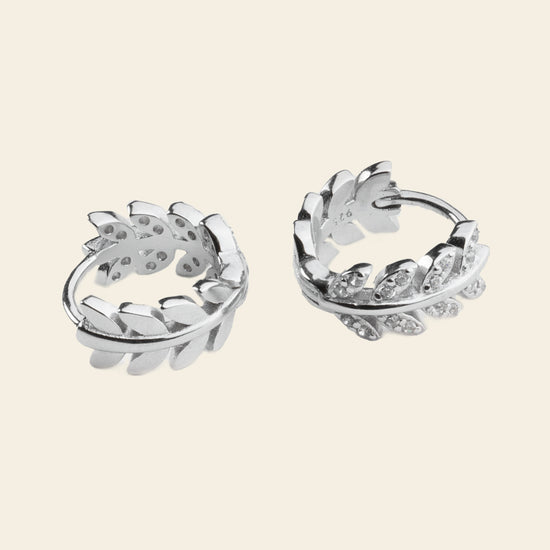 Laurel Arc Earrings with small hoops with leaf-shaped details in silver finish