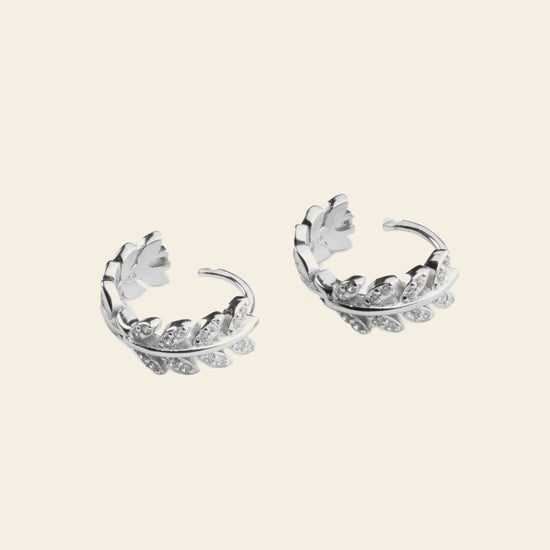 Laurel Arc Earrings with small hoops with leaf-shaped details in silver finish