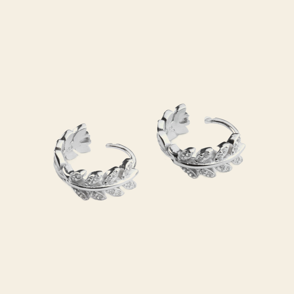 Laurel Arc Earrings with small hoops with leaf-shaped details in silver finish