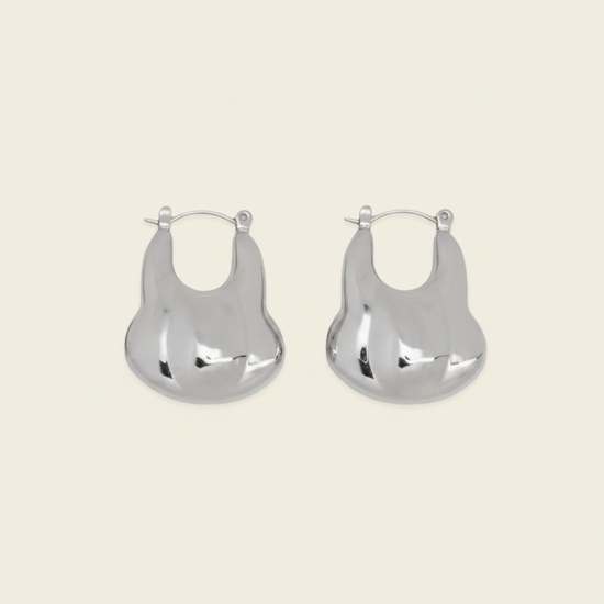 Liquid Loop Earrings with broad polished irregular hoop shapes in silver finish