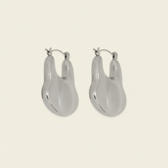 Liquid Loop Earrings with broad polished irregular hoop shapes in silver finish