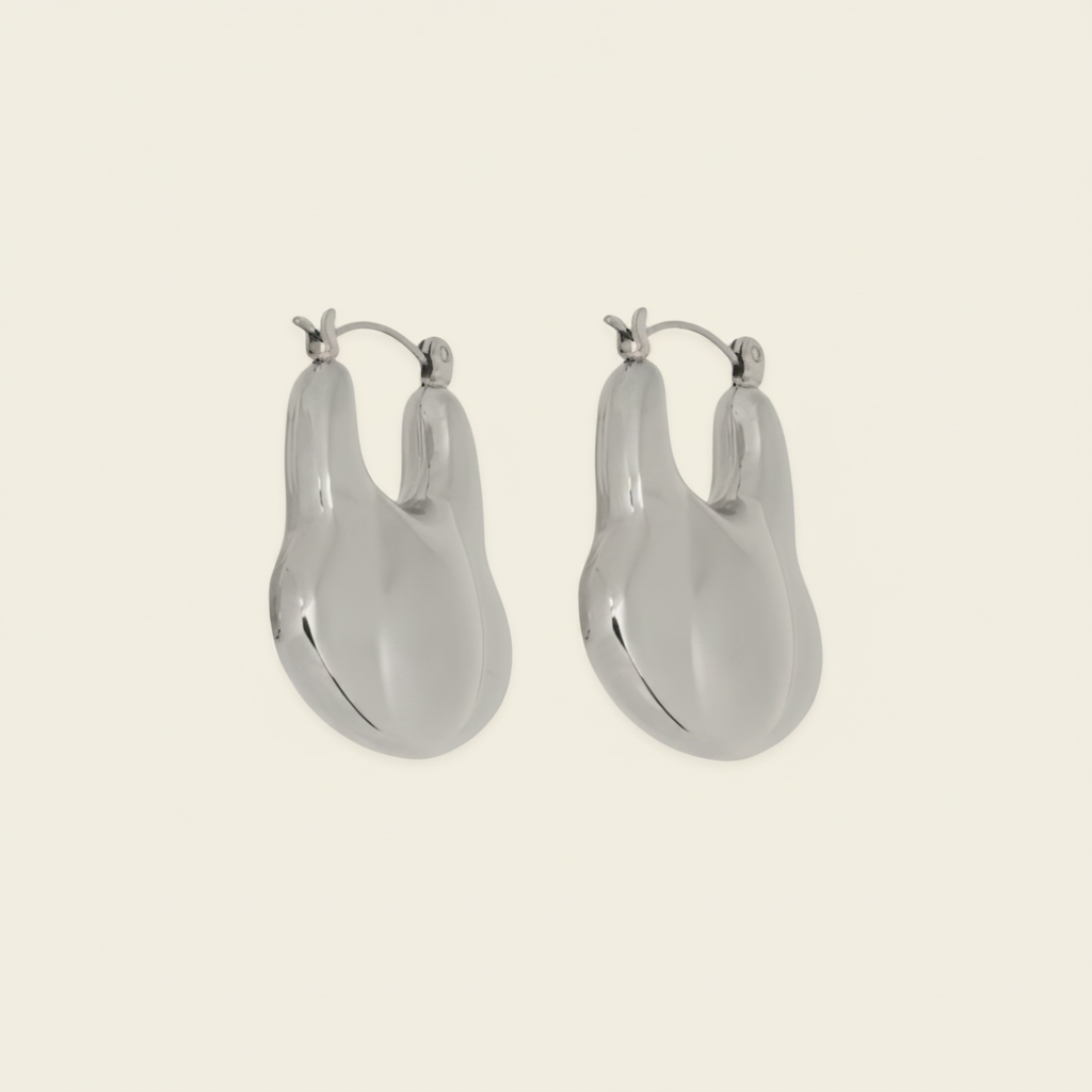 Liquid Loop Earrings with broad polished irregular hoop shapes in silver finish