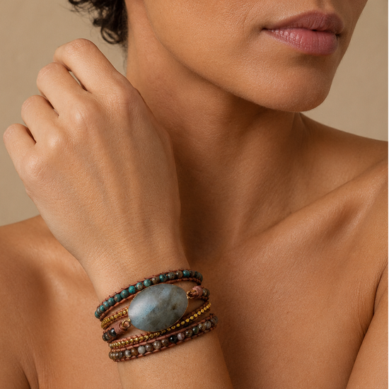Luna Crest Bracelet worn on the wrist, with layered earth-toned beads and an oval stone centre