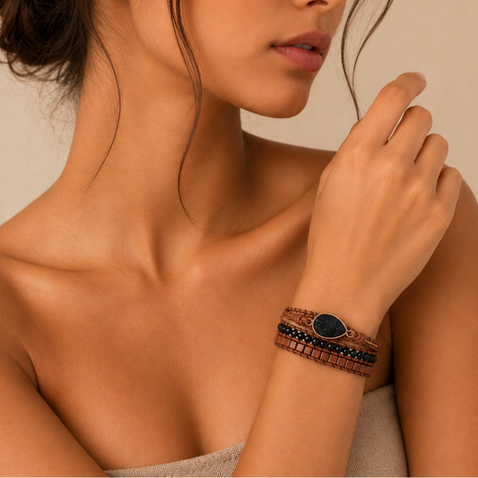 Midnight Ember Bracelet worn on the wrist, with dark and earth-toned beads on brown cord