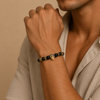 Midnight Skull Bracelet worn on the wrist, with dark round beads and skull-shaped metal accents