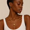 Molten Drop Necklace worn at the neckline in gold finish