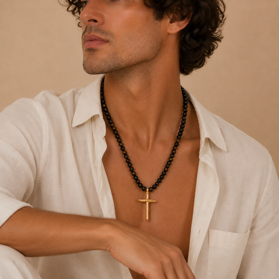 Obsidian Might Necklace worn at the neckline, with dark beads and a cross pendant