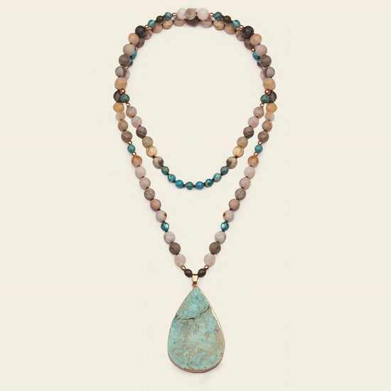 Ocean Drift Necklace with earth-toned beads and a turquoise-coloured teardrop pendant