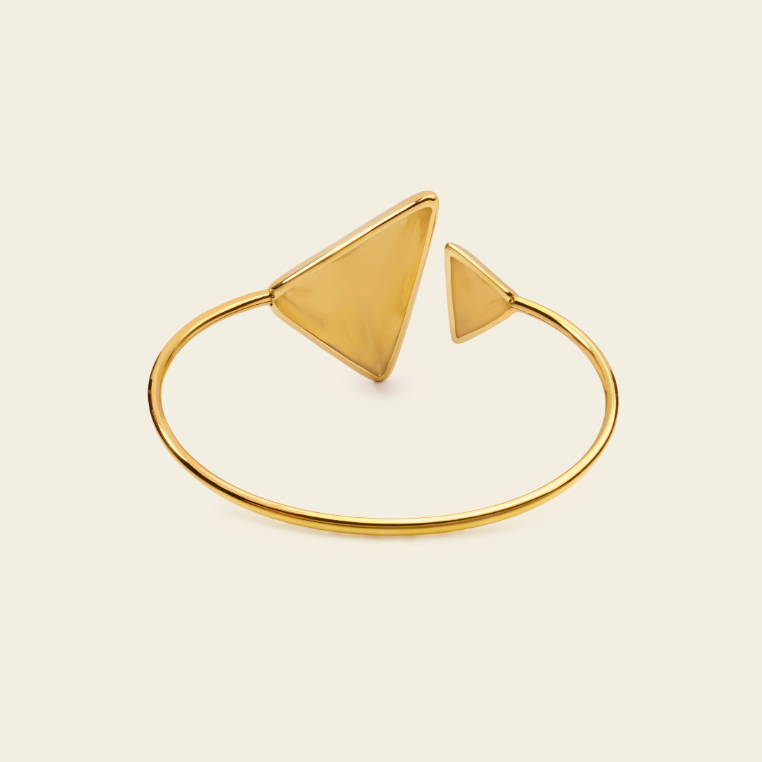 Offset Apex Cuff with an open band with asymmetric triangular ends in gold finish