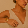 Offset Apex Cuff worn on the wrist in gold finish