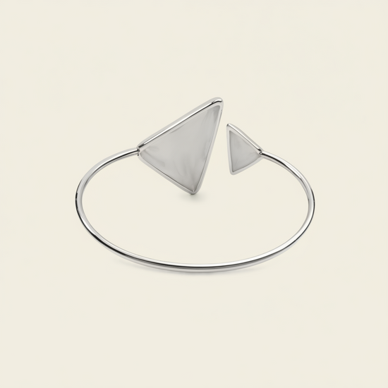 Offset Apex Cuff with an open band with asymmetric triangular ends in silver finish
