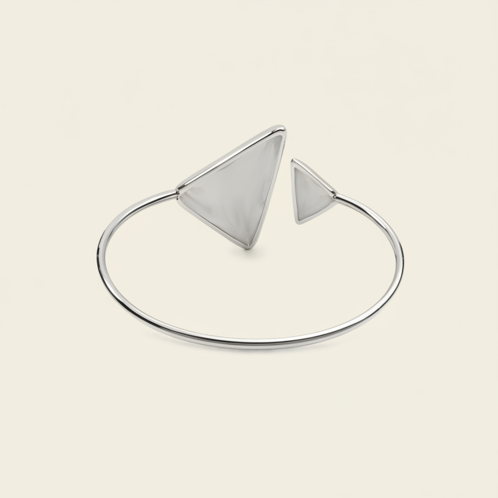 Offset Apex Cuff with an open band with asymmetric triangular ends in silver finish